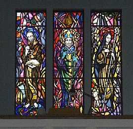 Stained glass window of St Colmcille, St Patrick and St Brigid