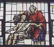Stained glass window showing the Good Samaritan